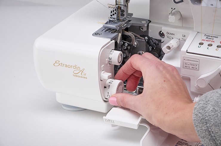 Dials to adjust stitch length for rolled hem and regular serging stiches