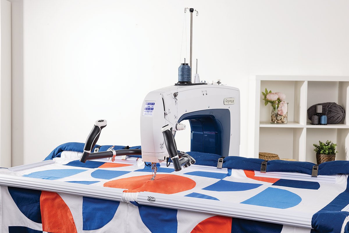 Grace 16X midarm quilting machine with quilt on frame